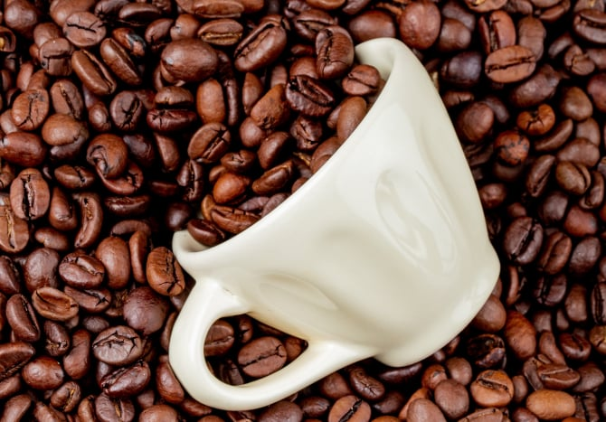 top-view-roasted-coffee-beans-scattered-from-ceramic-cup-coffee-beans_29192300 (1)